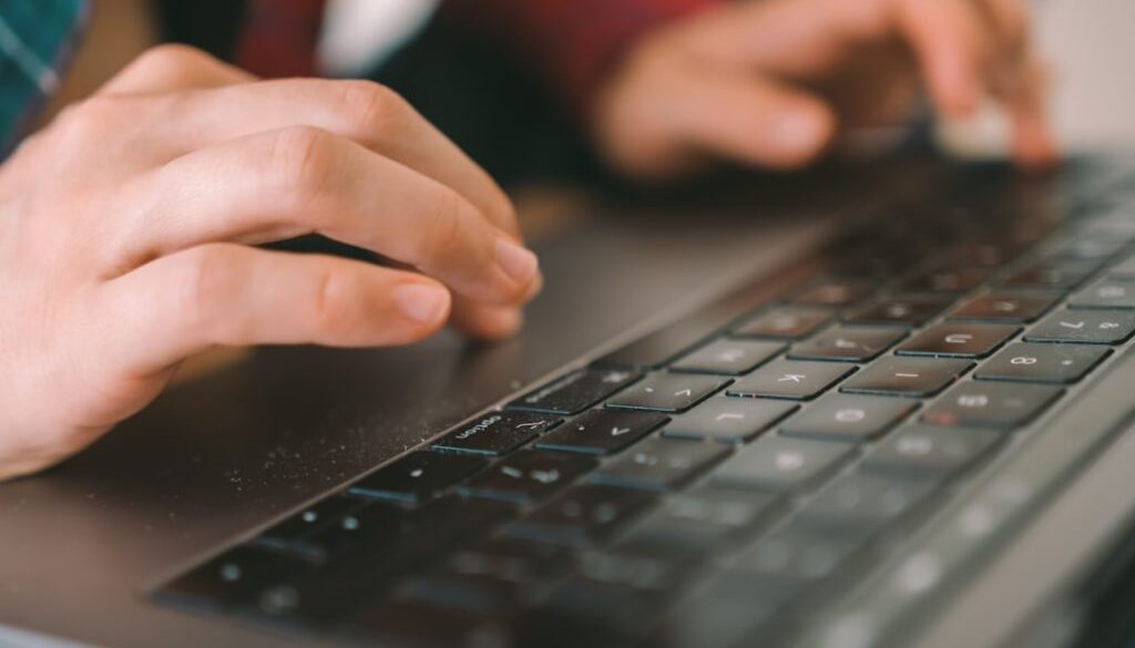 persons-hand-on-black-computer-keyboard-hfk67rqmwlw
